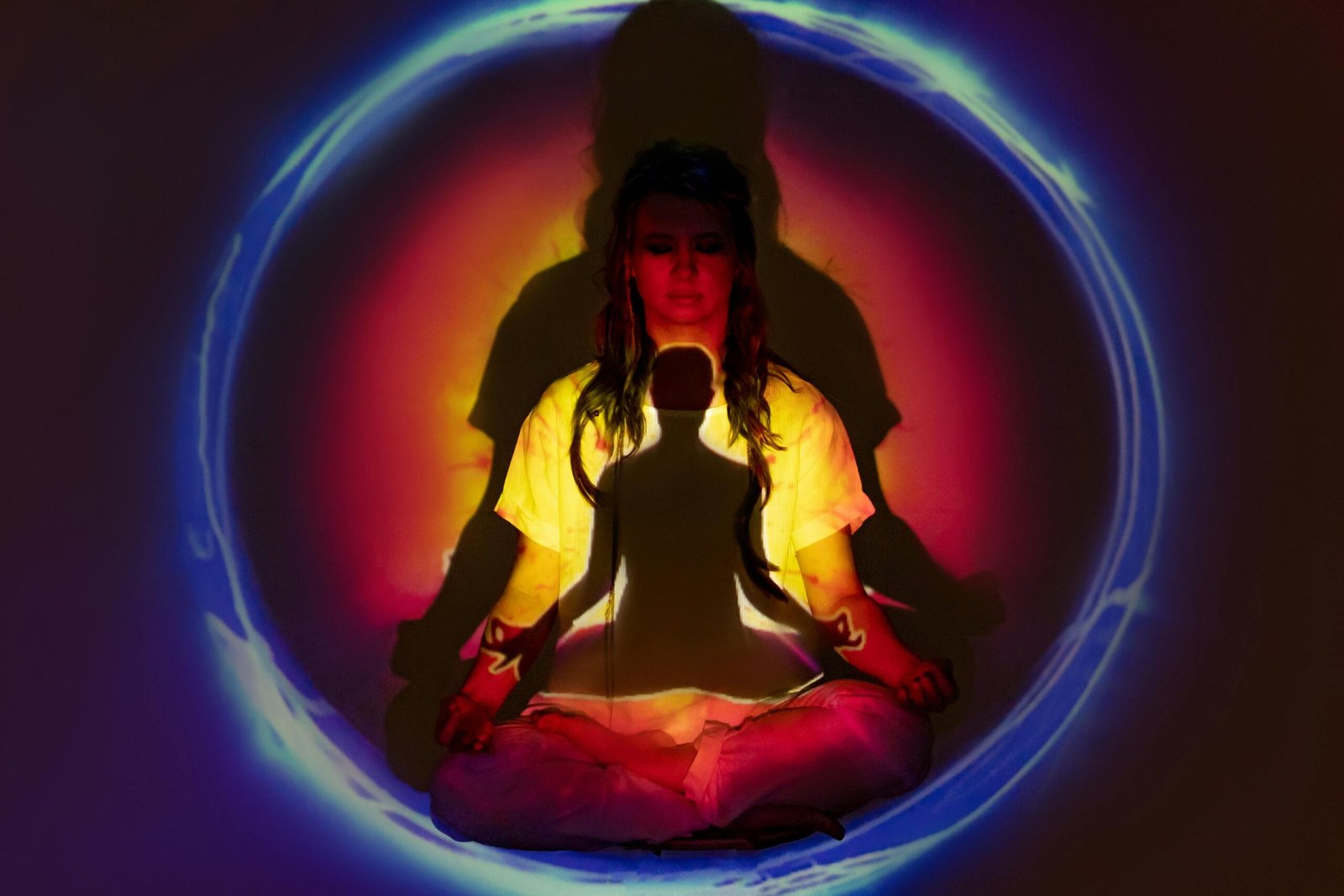 pexels-photo-6931924-6931924 A woman in meditation surrounded by colorful auric light, creating a spiritual atmosphere.