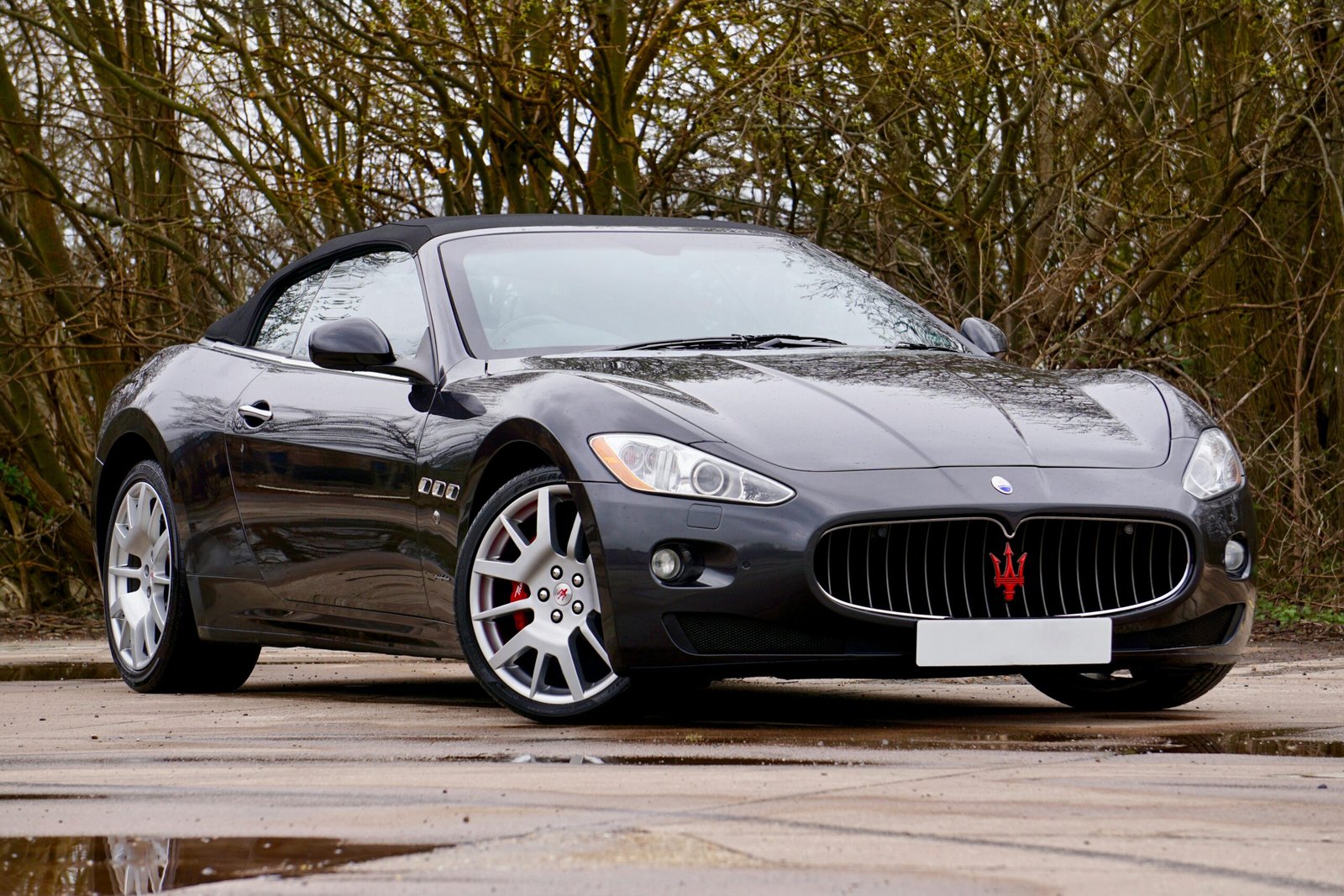 Sleek Maserati convertible parked outdoors, reflecting elegance and power.