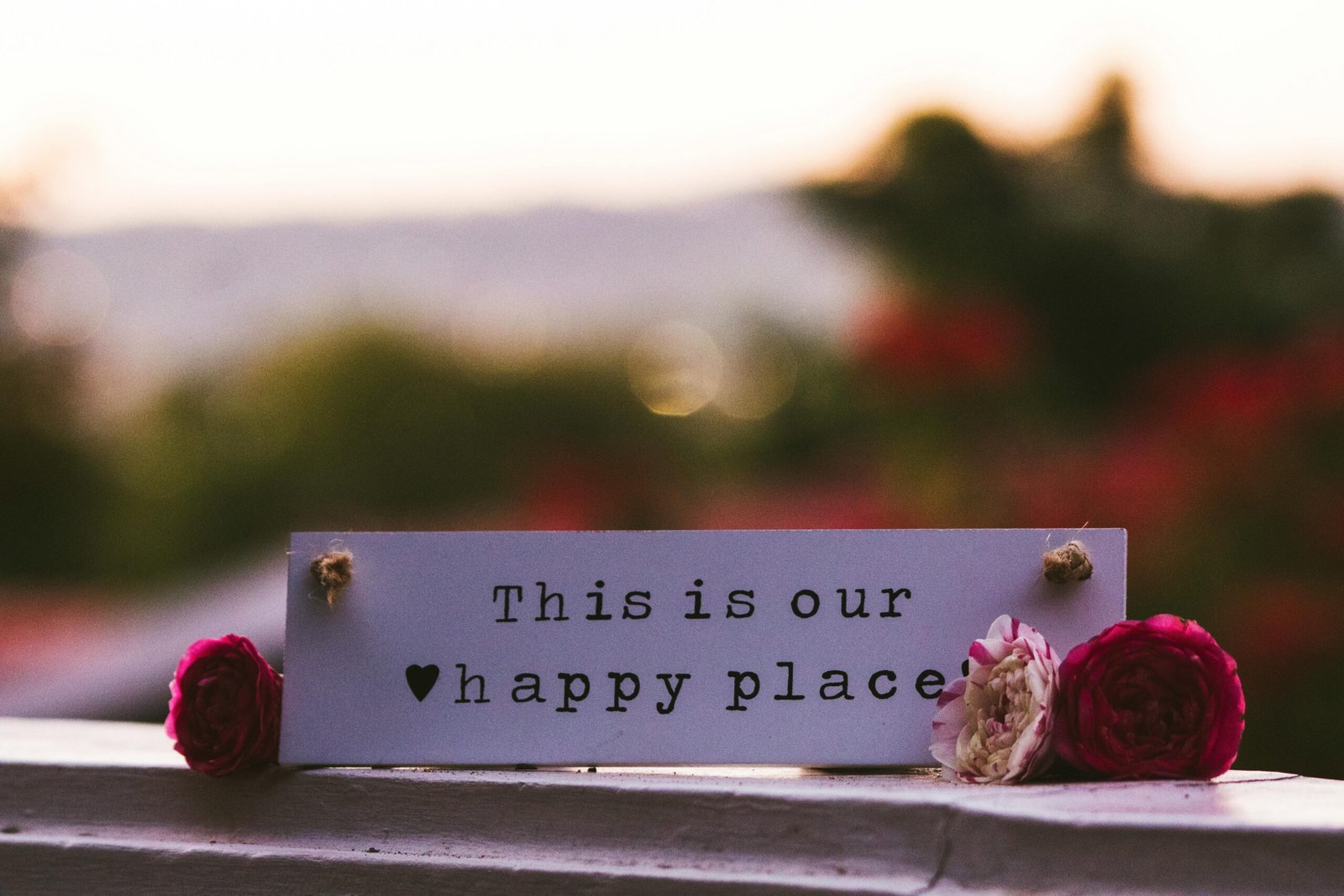 pexels-photo-5350055-5350055 A close-up of a decorative card with flowers, conveying an inspiring message 'This is our happy place'.